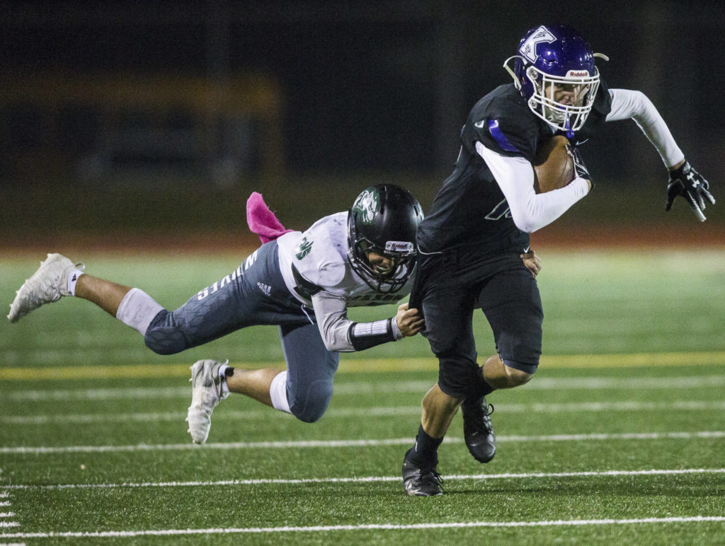 Kamiak’s Carson Doyle is tackled by Jackson’s Daniel Ramirez during the game on Nov. 1, 2019 in Everett, Wash. (Olivia Vanni / The Herald)
