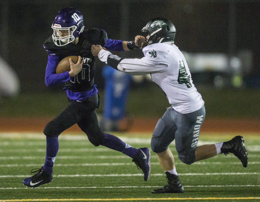 Kamiak’s Nick Laman grabs Jackson’s Jack Barclay facemask during the game on Nov. 1, 2019 in Everett, Wash. (Olivia Vanni / The Herald)
