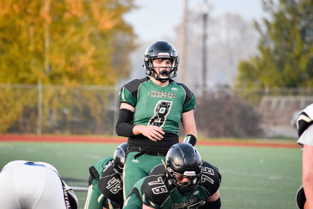 Senior quarterback Caleb Blonk looks at the defense before starting the play against Lynnwood on Friday, Nov. 1 at Quil Ceda Stadium in Marysville. (Katie Webber / The Herald)
