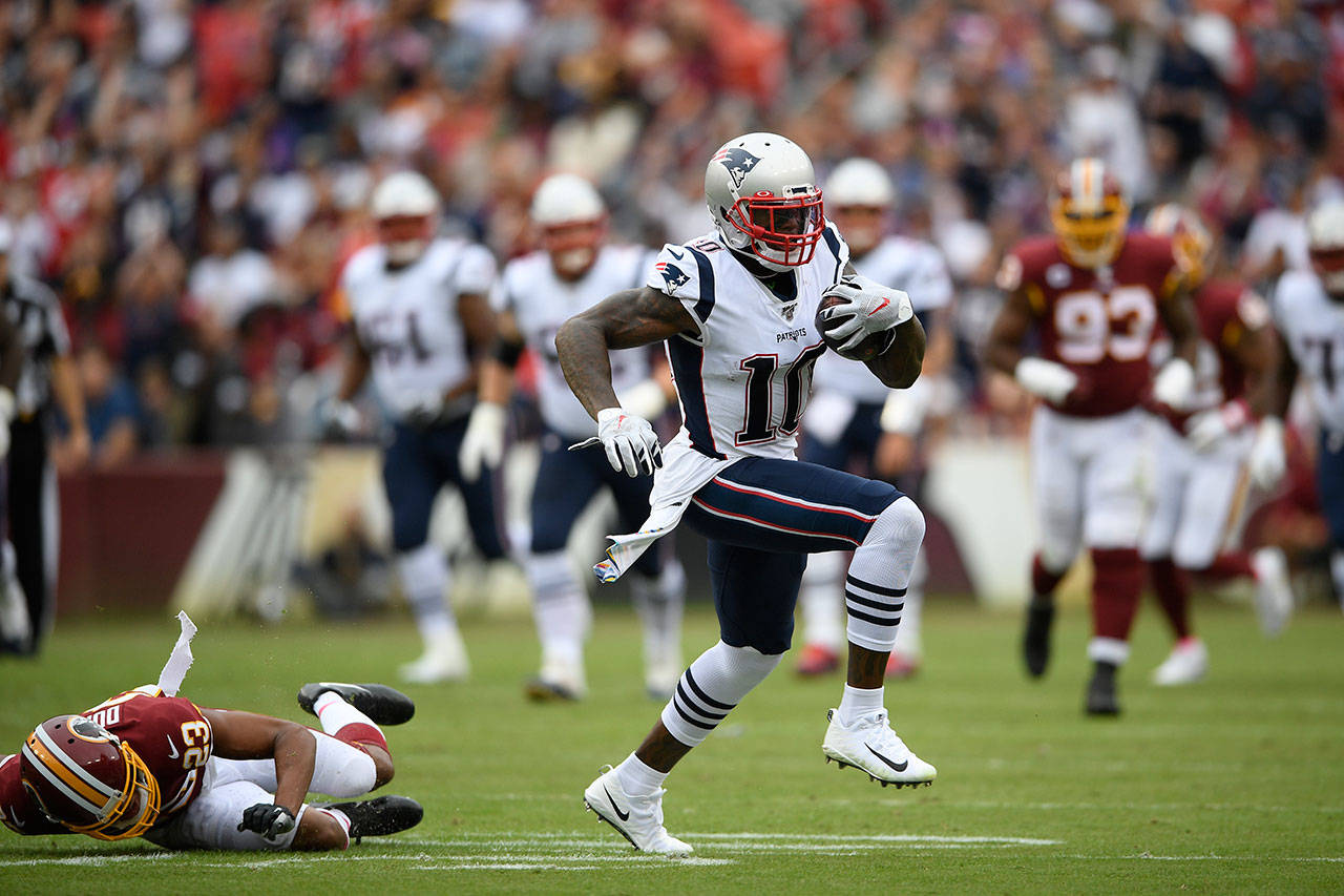 Wide receiver Josh Gordon (10) runs around Redskins cornerback Quinton Dunbar (23) during a game with the Patriots on Oct. 6 in Landover, Md. The Seahawks claimed Gordon off of waivers on Friday. (AP Photo/Nick Wass)