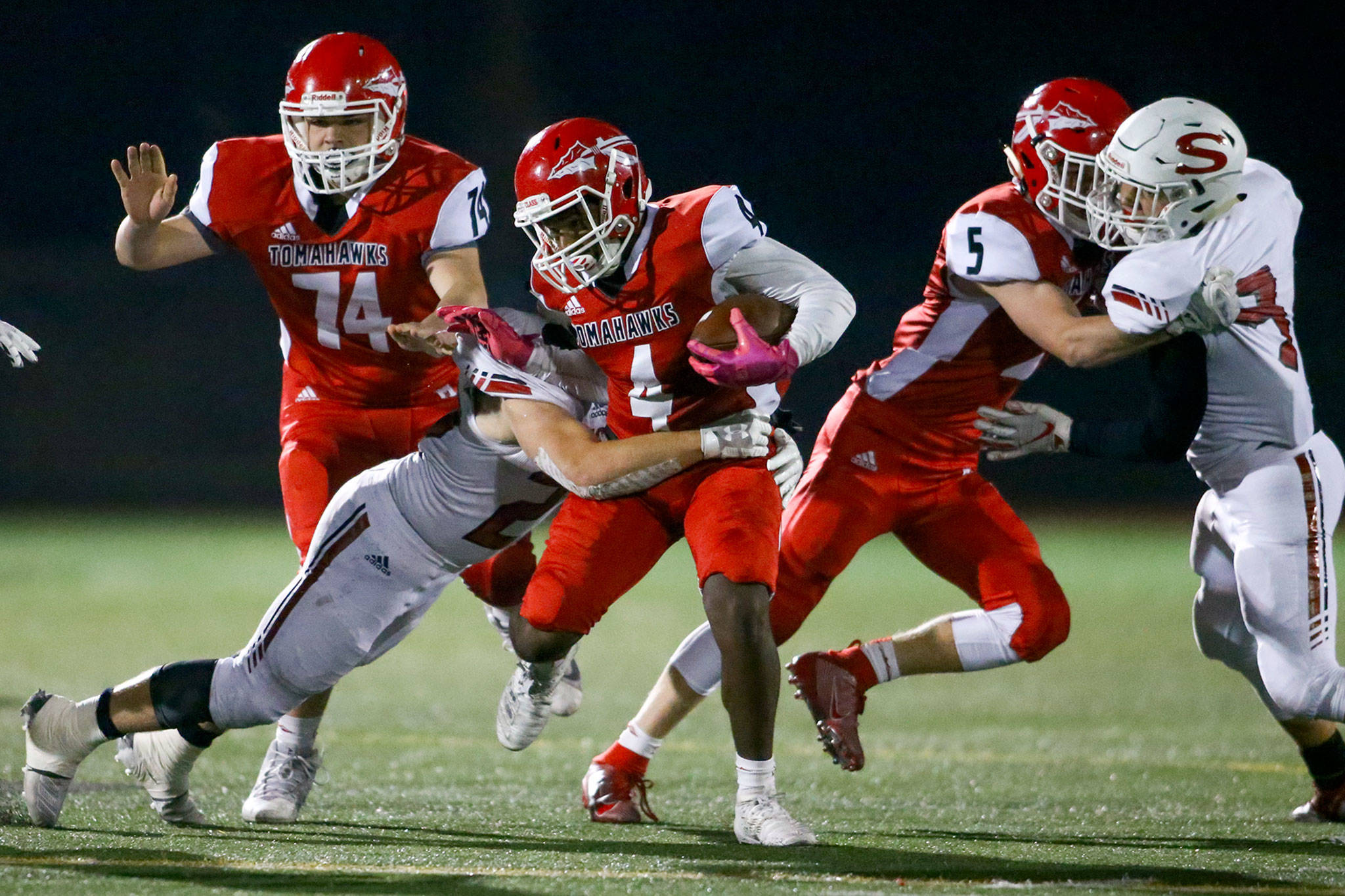 Marysville Pilchuck’s Jay Gray runs for yardage during the Tomahawks’ 52-3 rout of Snohomish in the Wesco 3A championship game Friday night at Quil Ceda Stadium. (Kevin Clark / The Herald)