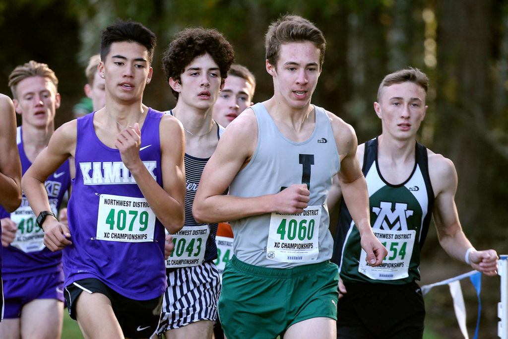 Jackson’s Brenden Charbeneau (#4060) leads the pack and finished first in the 4A division Saturday during the District 1 Cross Country Championship at South Whidbey High School in Langley on Saturday. (Kevin Clark / The Herald)
