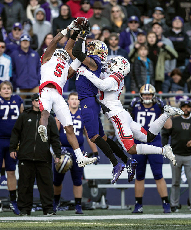 Utah defensive backs Tareke Lewis (left) and Julian Blackmon (right) battle Washington receiver Marquis Spiker for the ball during the ninth-ranked Utes’ 33-28 win over the Huskies on Saturday afternoon at Husky Stadium. (AP Photo/Stephen Brashear)