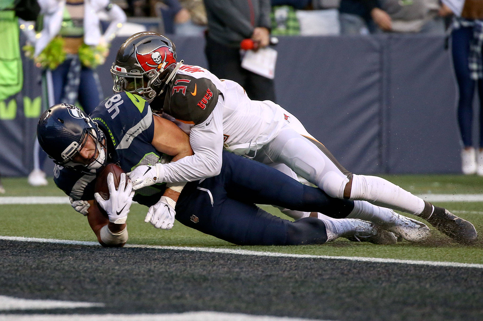 Seahawks Jacob Hollister falls across the goal line for the game winning touchdown against Buccaneers Jordan Whitehead in overtime Sunday afternoon at CenturyLink Field in Seattle on November 3, 2019.(Kevin Clark / The Herald)