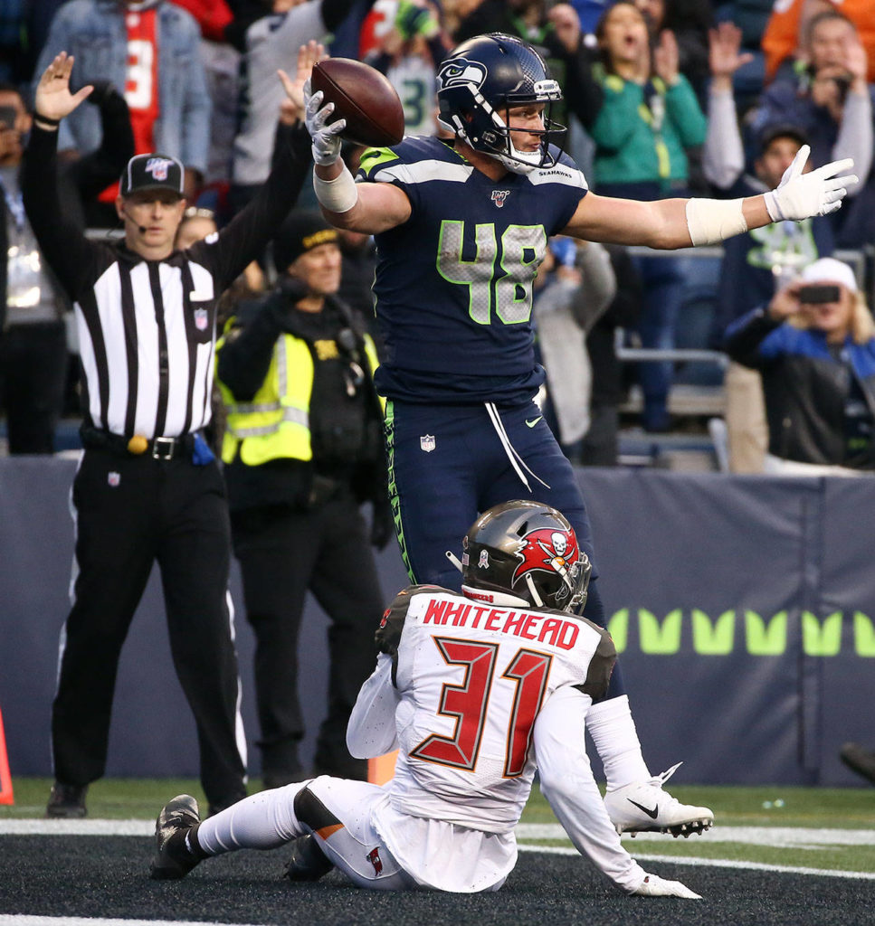 Seahawks Jacob Hollister celebrates his game winning touchdown against Buccaneers Jordan Whitehead in overtime Sunday afternoon at CenturyLink Field in Seattle on November 3, 2019.(Kevin Clark / The Herald)
