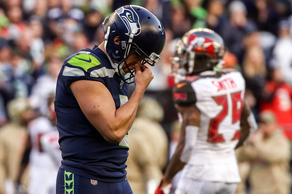 Seahawks Jason Myers is dejected after missing a game winning field goal forcing overtime against the Buccaneers Sunday afternoon at CenturyLink Field in Seattle on November 3, 2019. (Kevin Clark / The Herald)
