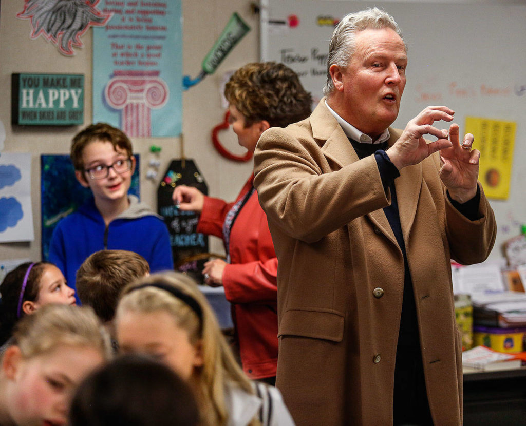 Seth Haney (left) talks with his teacher, Kimberlee Spaetig-Peterson, in her classroom at Riverview Elementary in Snohomish while Wonder Media CEO Terry Thoren explains his company’s Story Maker technology. (Dan Bates/The Herald)
