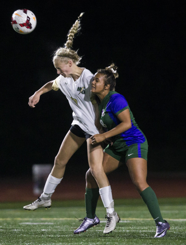 Edmonds-Woodway’s Sophia Martino-Crew pulls on Marysville Getchell’s Kirsten Crane’s jersey as she jump up for the ball at during the district semifinal game on Nov. 5, 2019 in Edmonds, Wash. (Olivia Vanni / The Herald)
