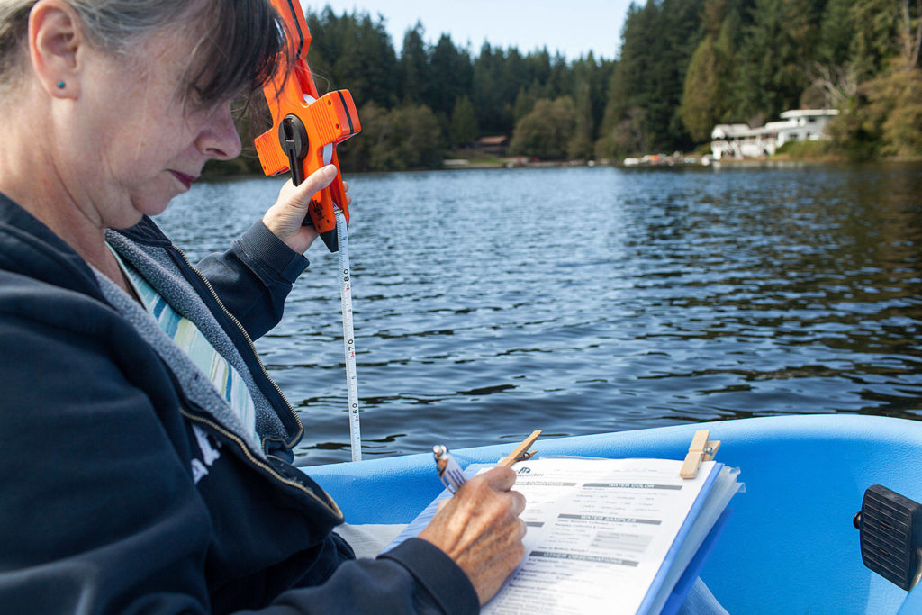 Deb Kocher is one of 73 volunteers monitoring 31 lakes through a Snohomish County Surface Water Management program. (Lizz Giordano / The Herald)
