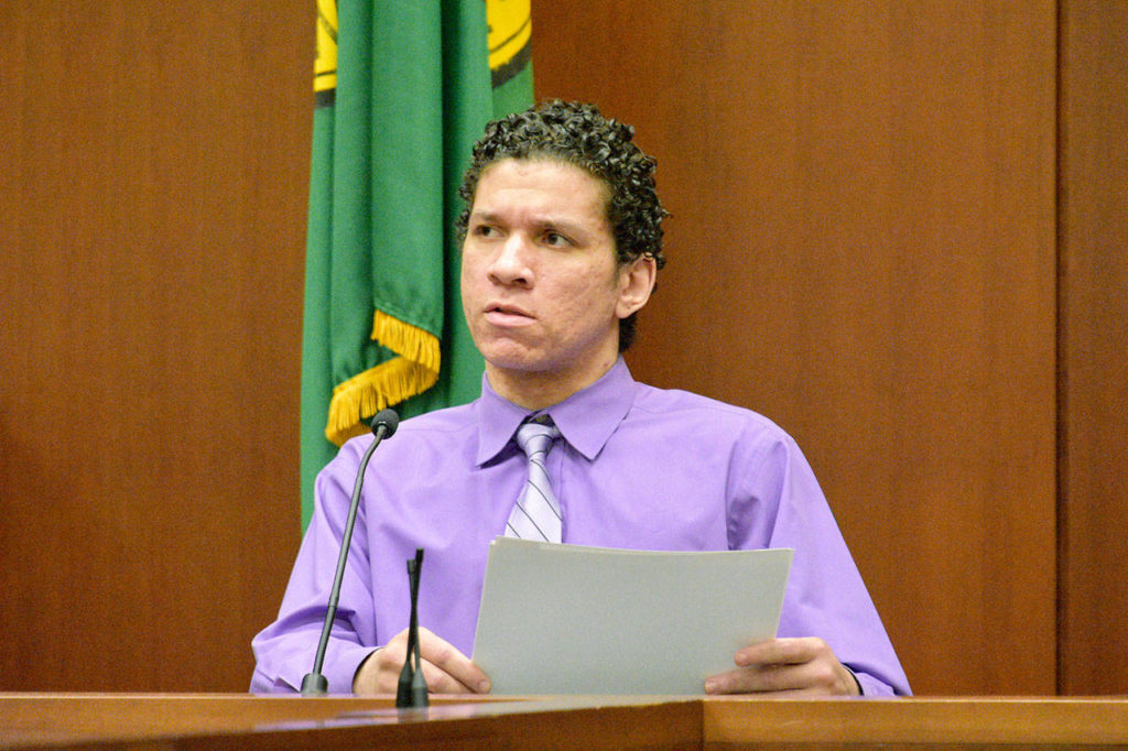 Matthew McGowan answers questions Friday about photographed evidence in his murder trial in Snohomish County Superior Court. McGowan is accused of beating homeless man Michael Boone, tying him to a tree and leaving him to die in freezing weather. (Caleb Hutton / The Herald)
