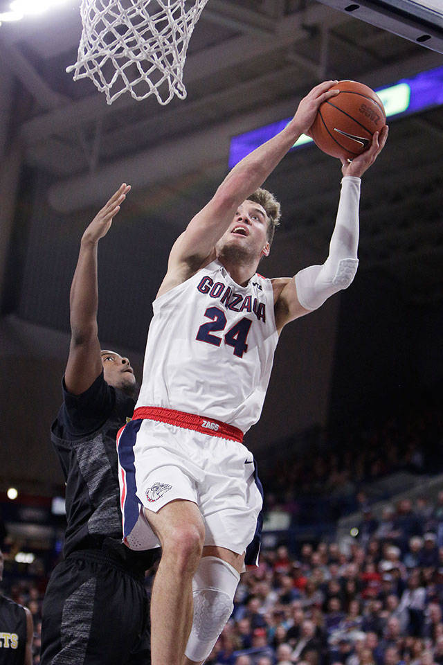 Gonzaga forward Corey Kispert (right) shoots while under pressure from Alabama State guard Austin Rogers during the first half of a game Tuesday in Spokane. (AP Photo/Young Kwak)