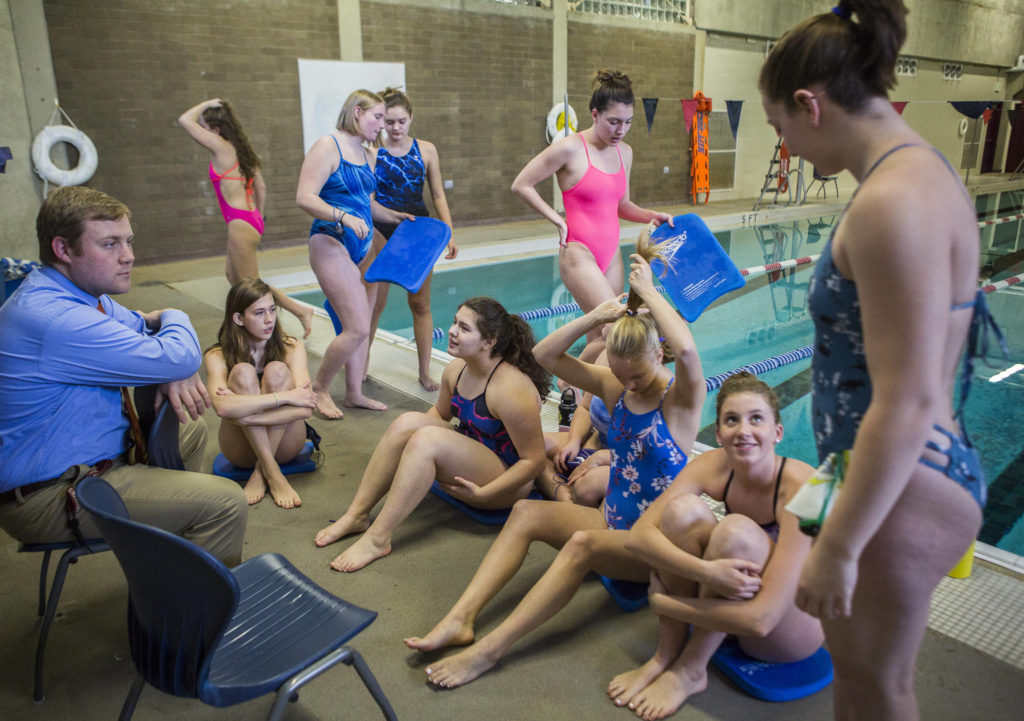 The Lake Stevens swim team grabs kickboards before the start of swim practice at Explorer Middle School on Nov. 6, 2019 in Everett, Wash. (Olivia Vanni / The Herald)
