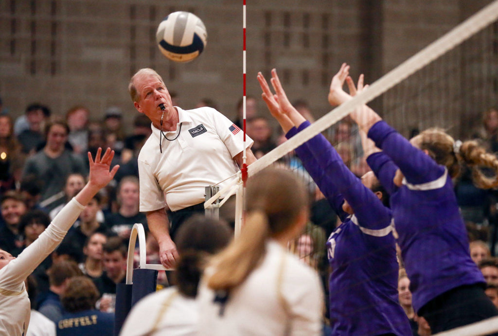 Referee Pat Kaminske tracks play at Arlington High School against Oak Harbor on October 24, 2019. Arlington won in straight sets. (Kevin Clark / The Herald)
