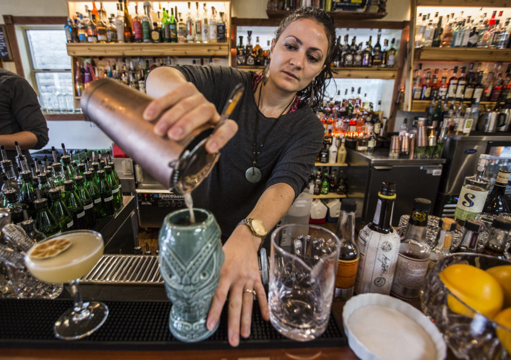 Kali Kelnero works on making a Clap of Thunder rum cocktail. (Olivia Vanni / The Herald)
