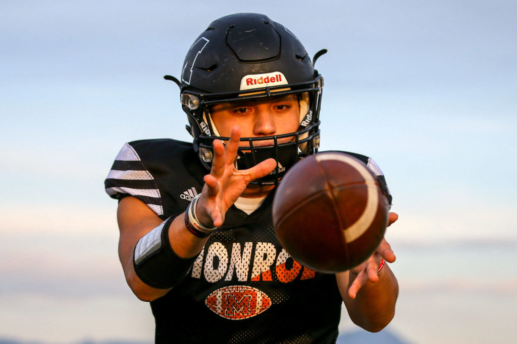 Monroe’s Gio Fregoso receives the snap during practice Wednesday at Monroe High School. The Bearcats face Mount Si in a playoff game Saturday. (Kevin Clark / The Herald)
