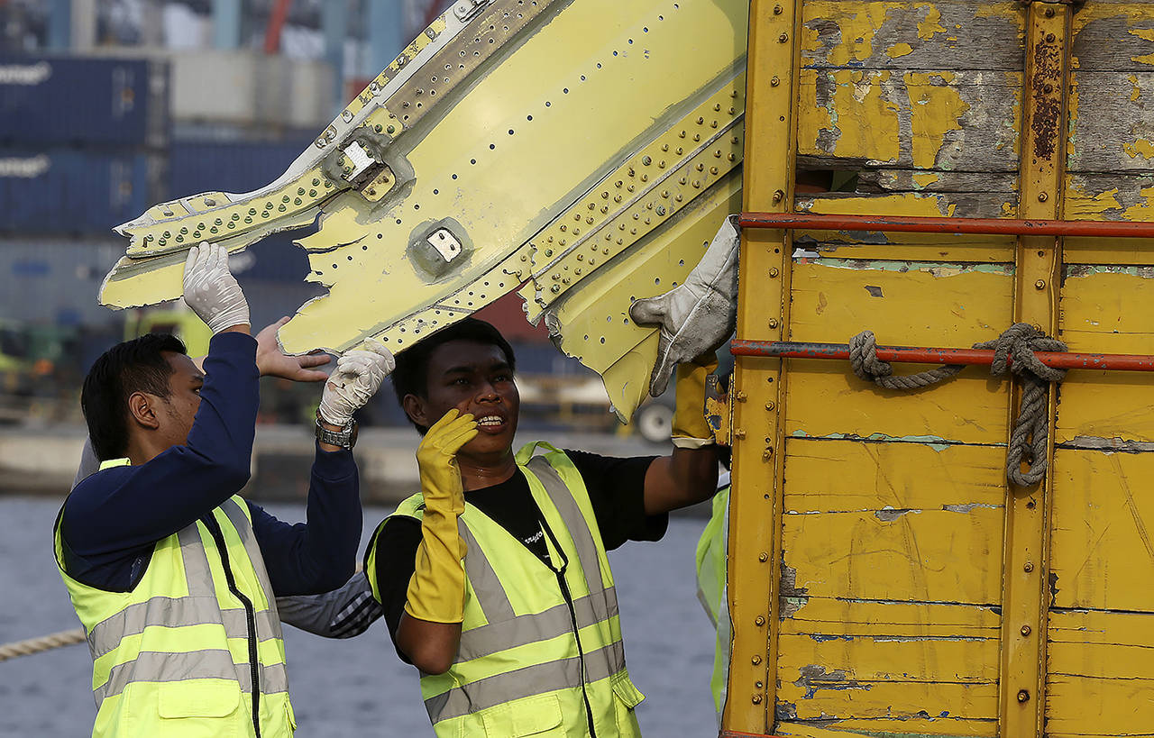 Officials move pieces of wreckage recovered from the crashed Lion Air jet for further investigation in Jakarta, Indonesia, on Nov. 4, 2018. (AP Photo/Achmad Ibrahim, file)