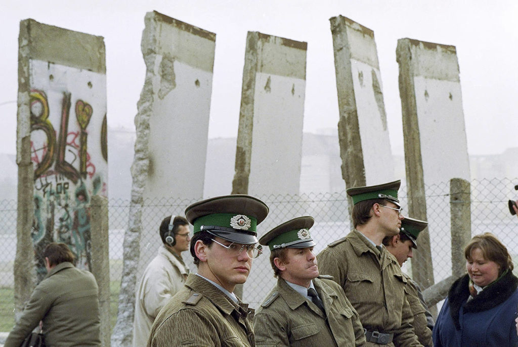 In this Nov. 13, 1989, photo, East German border guards stand in front of segments of the Berlin Wall, which were removed to open the wall at Potsdamer Platz passage in Berlin. (AP Photo/John Gaps III, File)

