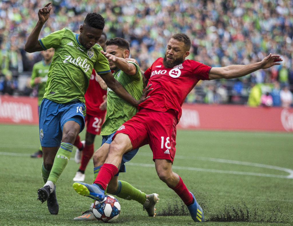 Sounders defender Kelvin Leerdam and Sounders midfielder Cristian Roldan fight Toronto midfielder Nick DeLeon for the ball during the MLS Cup on Nov. 10, 2019 in Seattle, Wash. (Olivia Vanni / The Herald)
