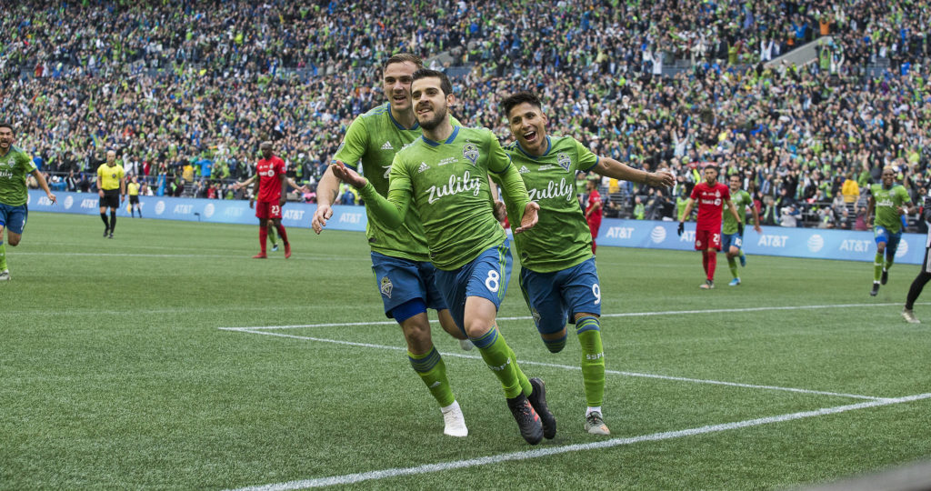 Sounders midfielder Víctor Rodríguez, center celebrates his goal with teammates Jordan Morris, left, and Raúl Ruidíaz. The Seattle Sounders beat Toronto FC 3-1 to win the MLS Cup at CenturyLink Field on Sunday, Nov. 10, 2019 in Seattle, Wash. (Andy Bronson / The Herald)
