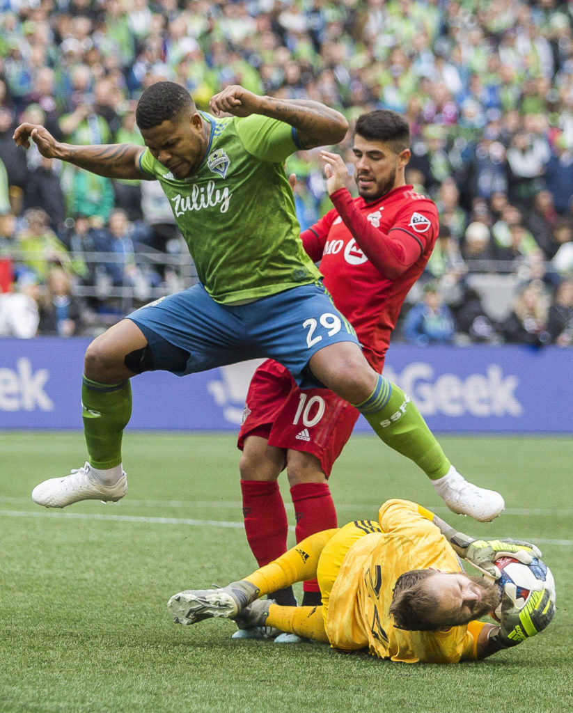 Sounders defender Román Torres jumps over Sounders goalkeeper Stefan Frei during the MLS Cup on Nov. 10, 2019 in Seattle, Wash. (Olivia Vanni / The Herald)
