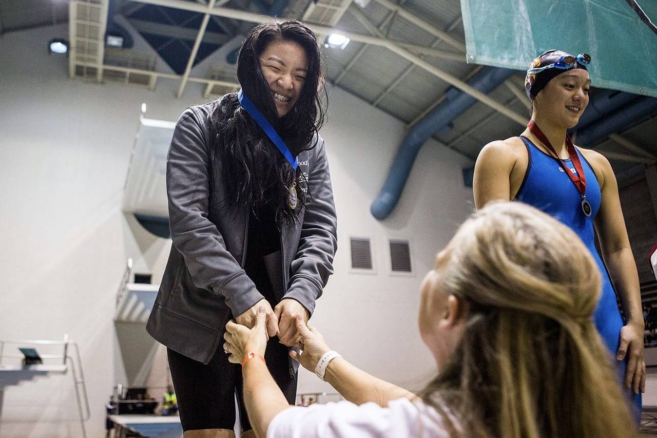 Stanwood swimmer Jetlynn Hau smiles after receiving her first-place state medal last year. The swim and dive state championships are among the highlights during this busy week of prep sports postseason action. (Olivia Vanni / The Herald)