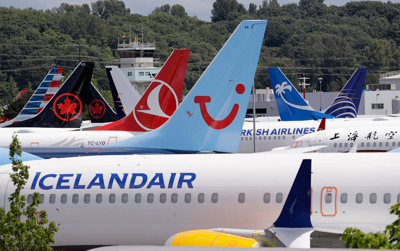 Dozens of grounded Boeing 737 Max airplanes crowd a parking area adjacent to Boeing Field in Seattle in June. (AP Photo/Elaine Thompson, File)