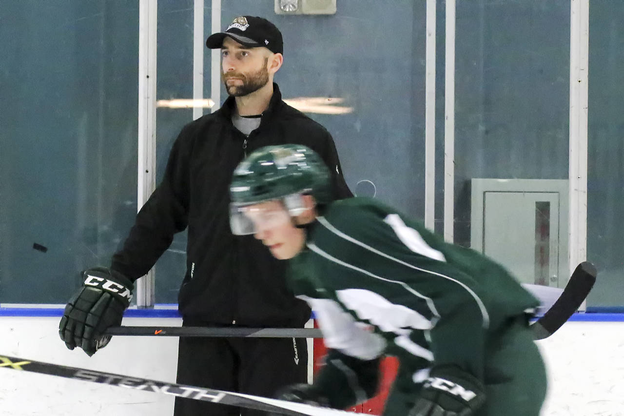 Everett Silvertips assistant coach Mitch Love looks on during a practice session in 2015. (Kevin Clark / Herald file)