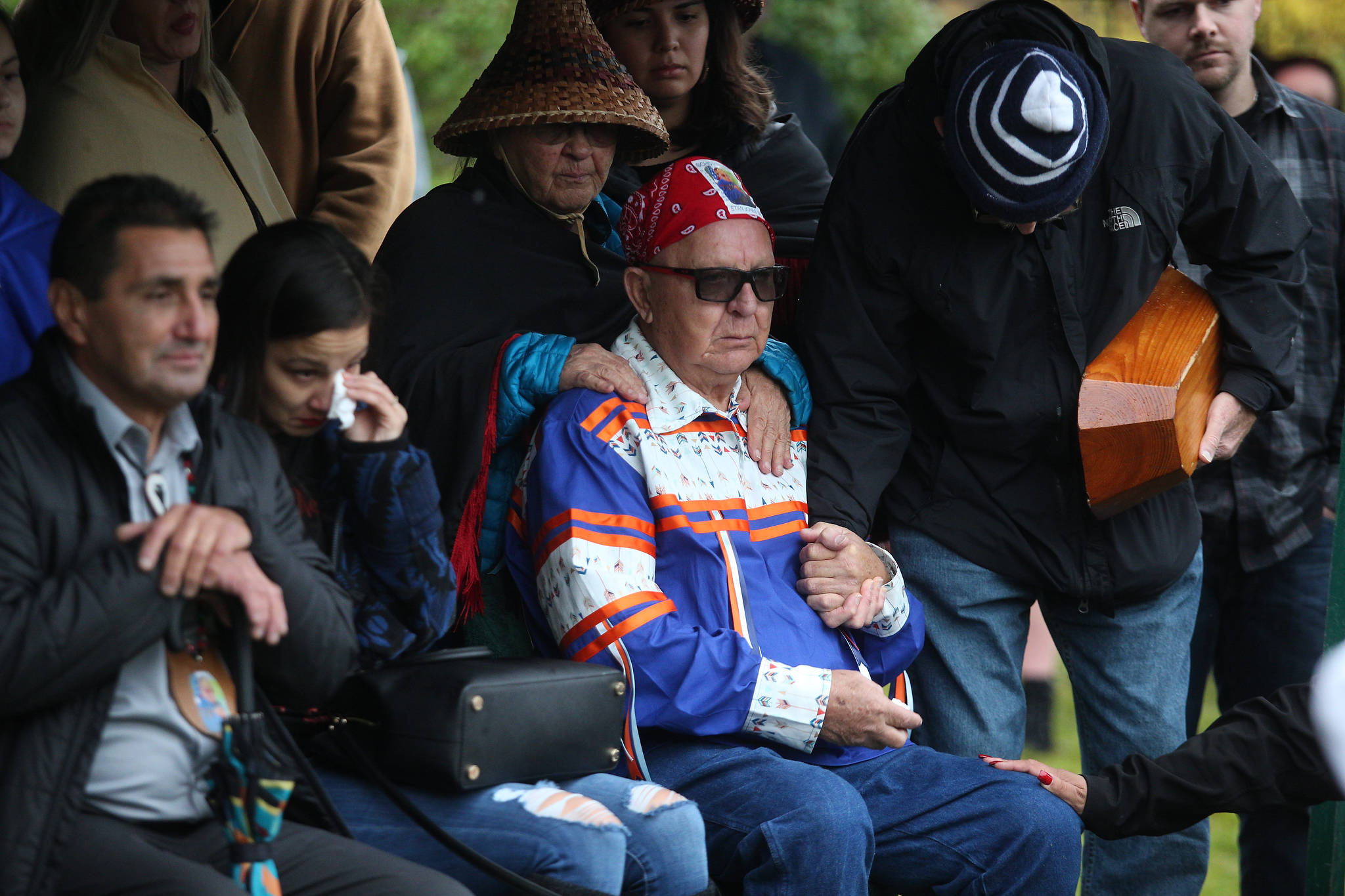 Dale Jones (center) is comforted as his brother, Stan Jones Sr., is buried at Mission Beach Cemetery on Tuesday on Tulalip Indian Reservation. Jones, 93, was the Tulalip Tribes longest serving board member and chairman. (Andy Bronson / The Herald)