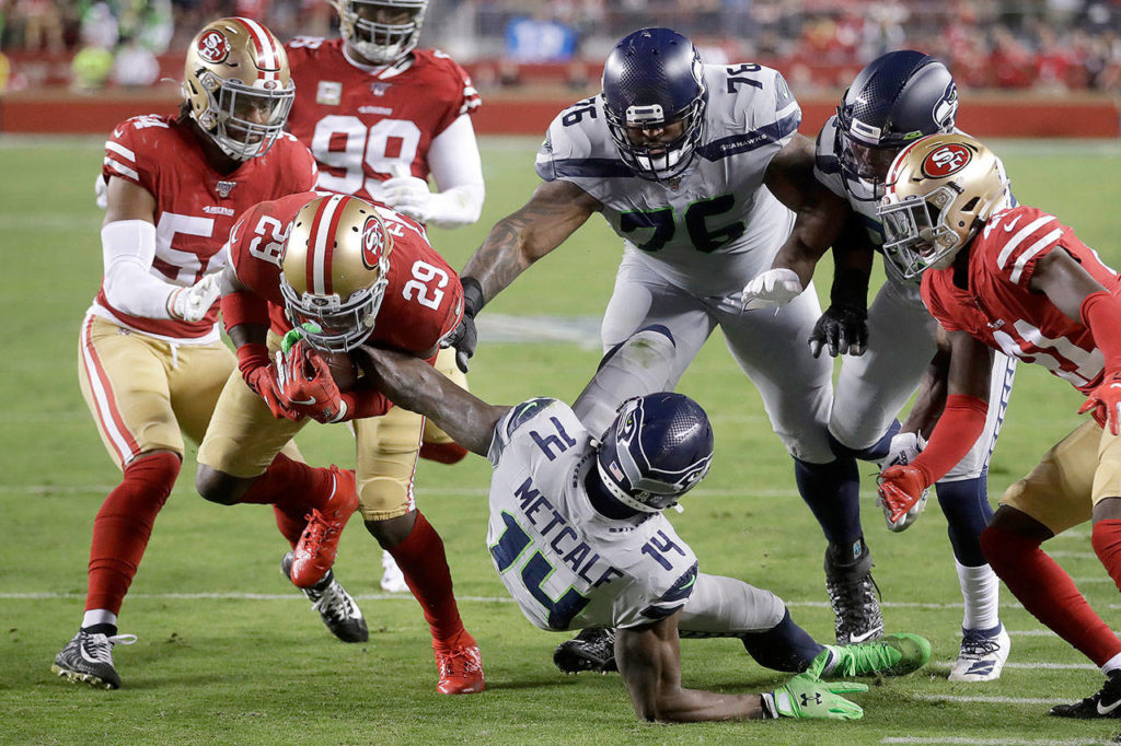 San Francisco 49ers strong safety Jaquiski Tartt (29) strips the ball from Seattle Seahawks wide receiver D.K. Metcalf (14) during the first half of an NFL football game in Santa Clara, California, on Monday. (AP Photo/Ben Margot)
