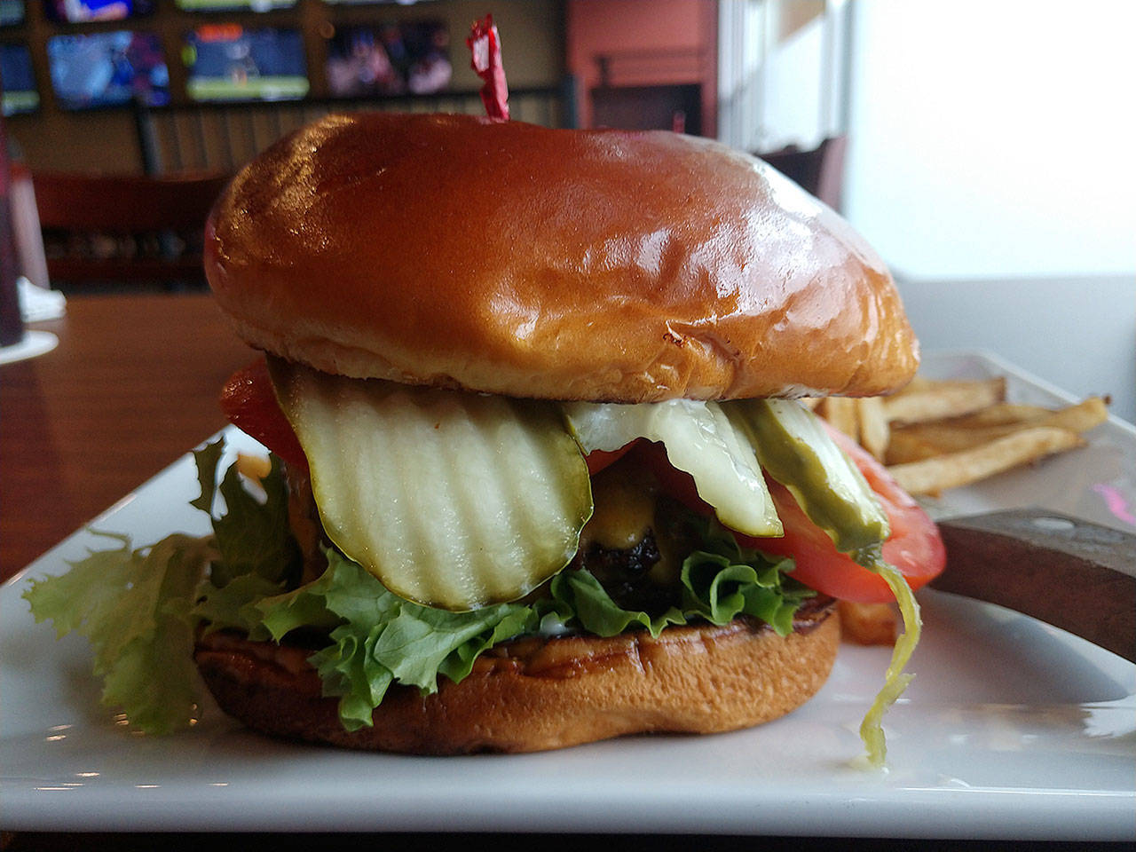 All burgers at Centennial Bar Grill in Arlington are ground in-house and hand-formed into half-pound patties. (Sara Bruestle / The Herald)