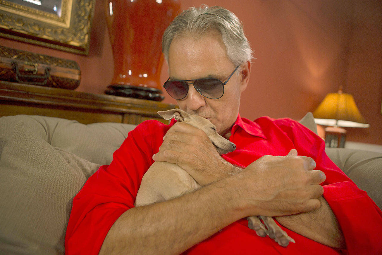 Italian tenor Andrea Bocelli with his dog, Katarina, during an interview Friday at his home in North Miami, Florida. Bocelli is defending opera legend Placido Domingo and calling it “absurd” that opera houses have canceled the star’s performances before sexual harassment allegations against him are fully investigated. Three U.S. music companies canceled Domingo appearances following allegations of sexual harassment made by multiple women earlier this year. (AP Photo/Ellis Rua)