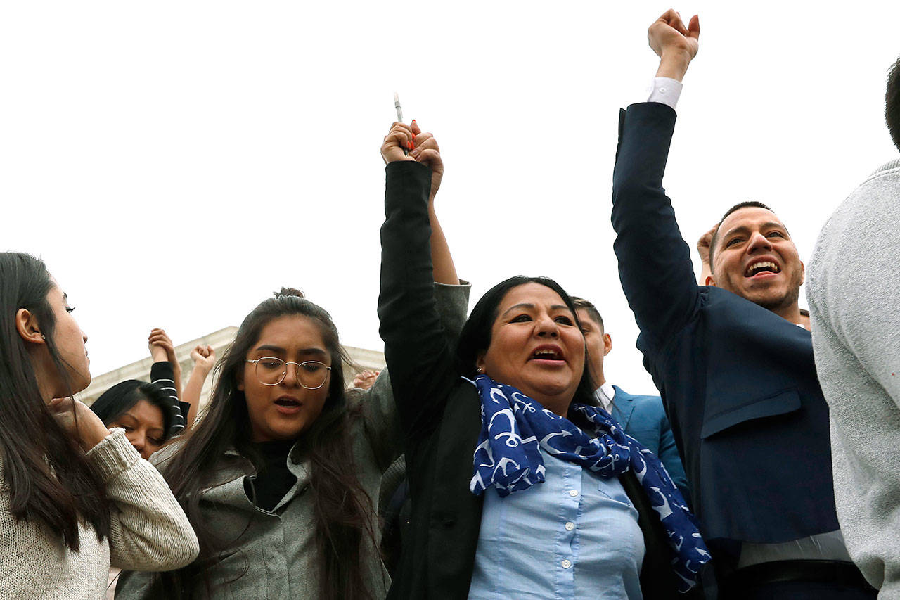 Martin Batalla Vidal (right), one of the lead plaintiffs, holds his hand up in the air as he walks with other DACA recipients and supporters from the Supreme Court after oral arguments were heard in the case of President Trump’s decision to end the Obama-era, Deferred Action for Childhood Arrivals program Tuesday in Washington. (AP Photo/Jacquelyn Martin)