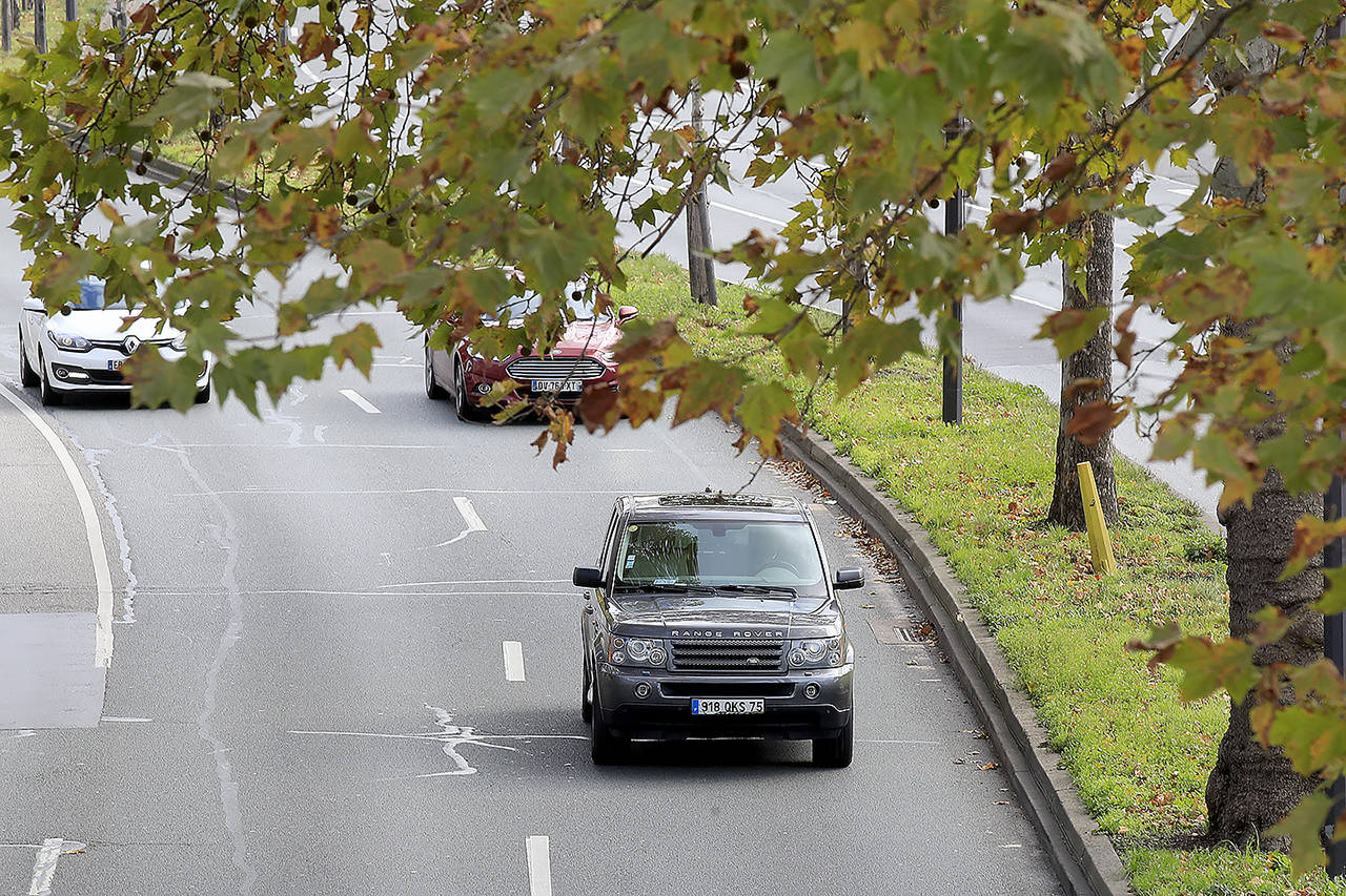 A SUV drives Nov. 13 in Paris. The world’s thirst for oil will continue to grow until the 2030s, with climate-damaging emissions climbing until at least 2040 — and consumers’ insatiable appetite for SUVs is a big reason why. (AP Photo/Michel Euler)