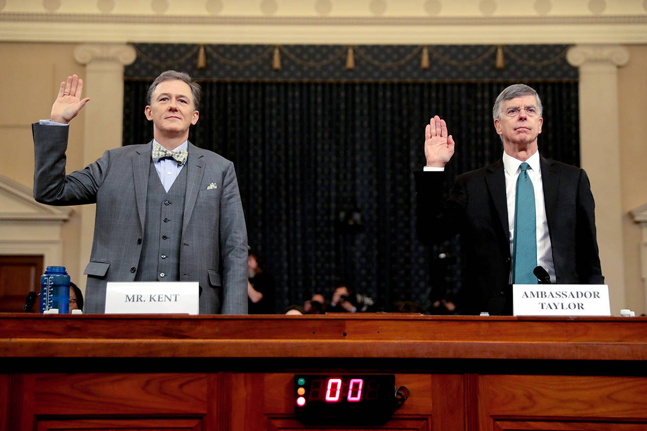 Career Foreign Service officer George Kent (left) and top U.S. diplomat in Ukraine William Taylor are sworn in to testify during the first public impeachment hearing of the House Intelligence Committee on Capitol Hill on Wednesday in Washington. (AP Photo/Andrew Harnik)