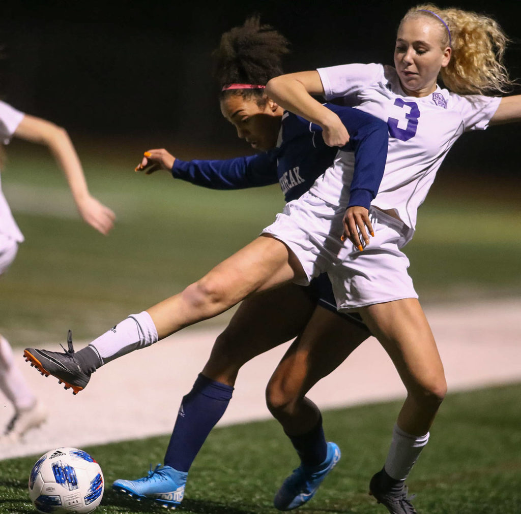 Glacier Peak’s Aaliyah Collins and Sumner’s Madison Morgan fight for control Wednesday evening at Glacier Peak High School in Snohomish on November 13, 2019. Sumner won 2-1. (Kevin Clark / The Herald)
