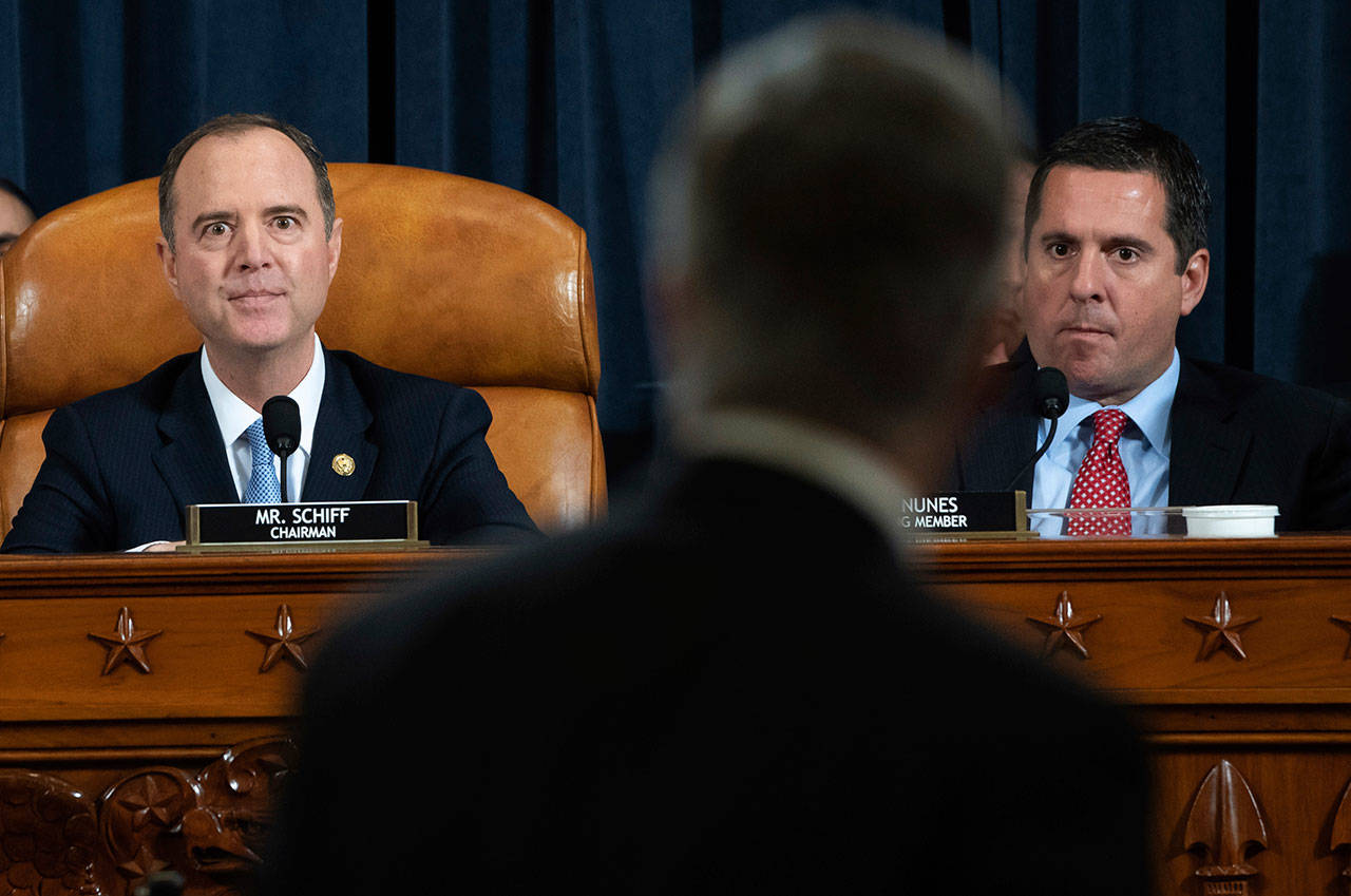 House Intelligence Committee Chairman Rep. Adam Schiff, D-California, (left) and ranking member Rep. Devin Nunes, R-California, watch as yop U.S. diplomat in Ukraine William Taylor leaves after testifying at a hearing of the House Intelligence Committee on Capitol Hill in Washington, Wednesday, during the first public impeachment hearing of President Trump’s efforts to tie U.S. aid for Ukraine to investigations of his political opponents. (Saul Loeb / Pool Photo)
