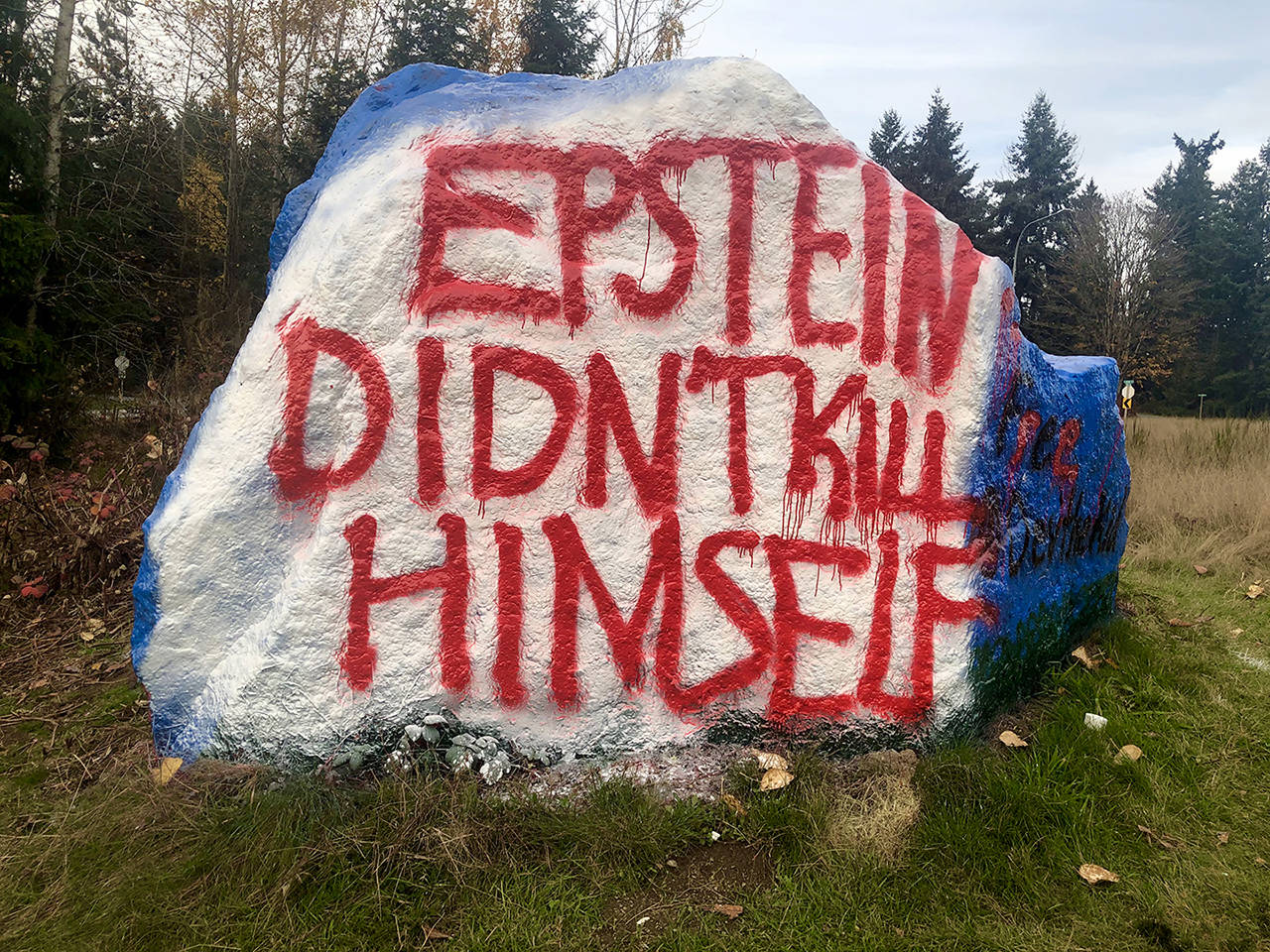 The boulder by Highway 9 in Snohomish, traditionally a canvas for pleasantries, recently was painted with a politically charged message. (Andrea Brown / The Herald)