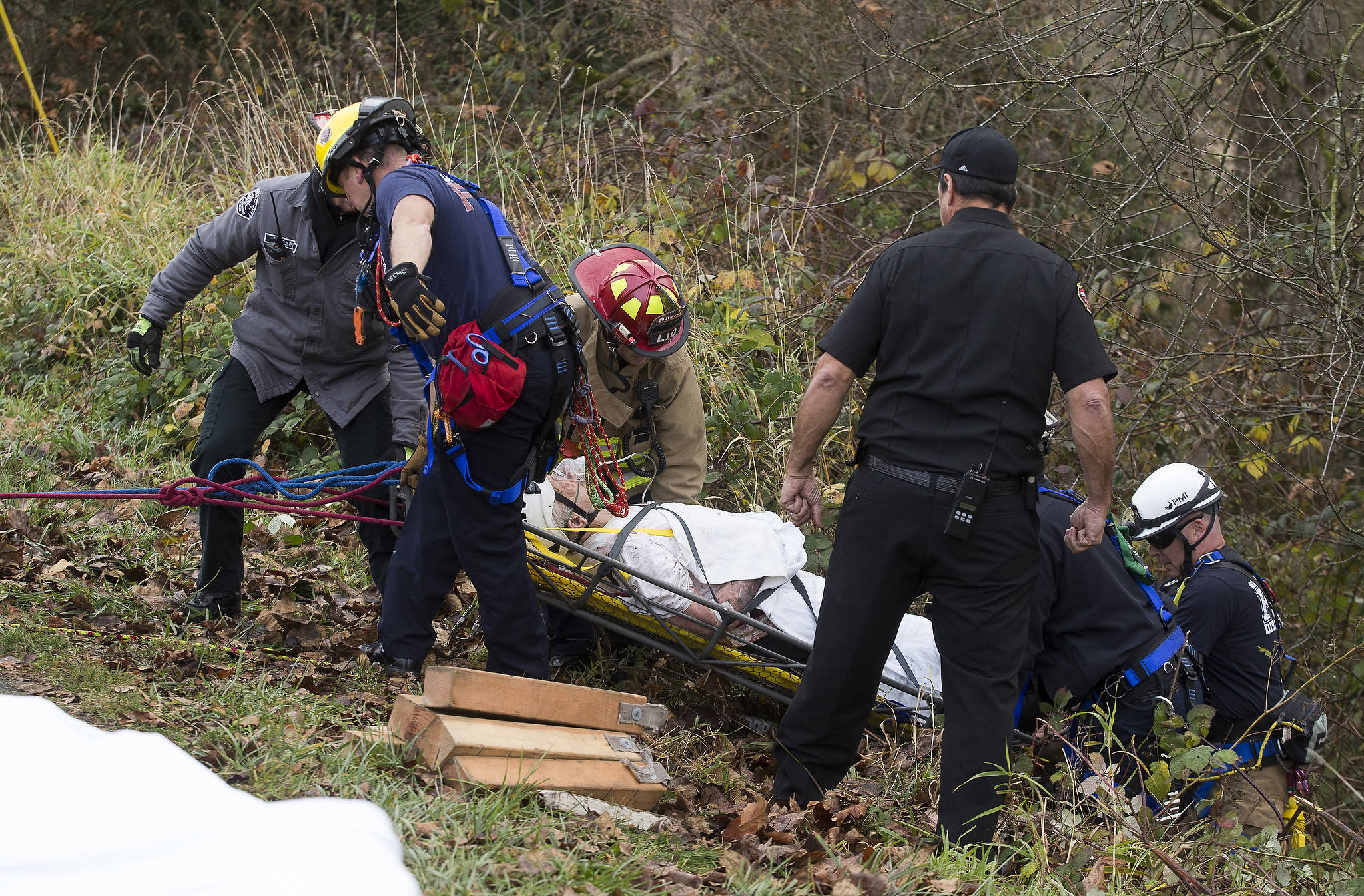 A man is rescued after his car went into a ravine at Riverview Road and 85th Avenue SE on Thursday in Snohomish. (Andy Bronson / The Herald)