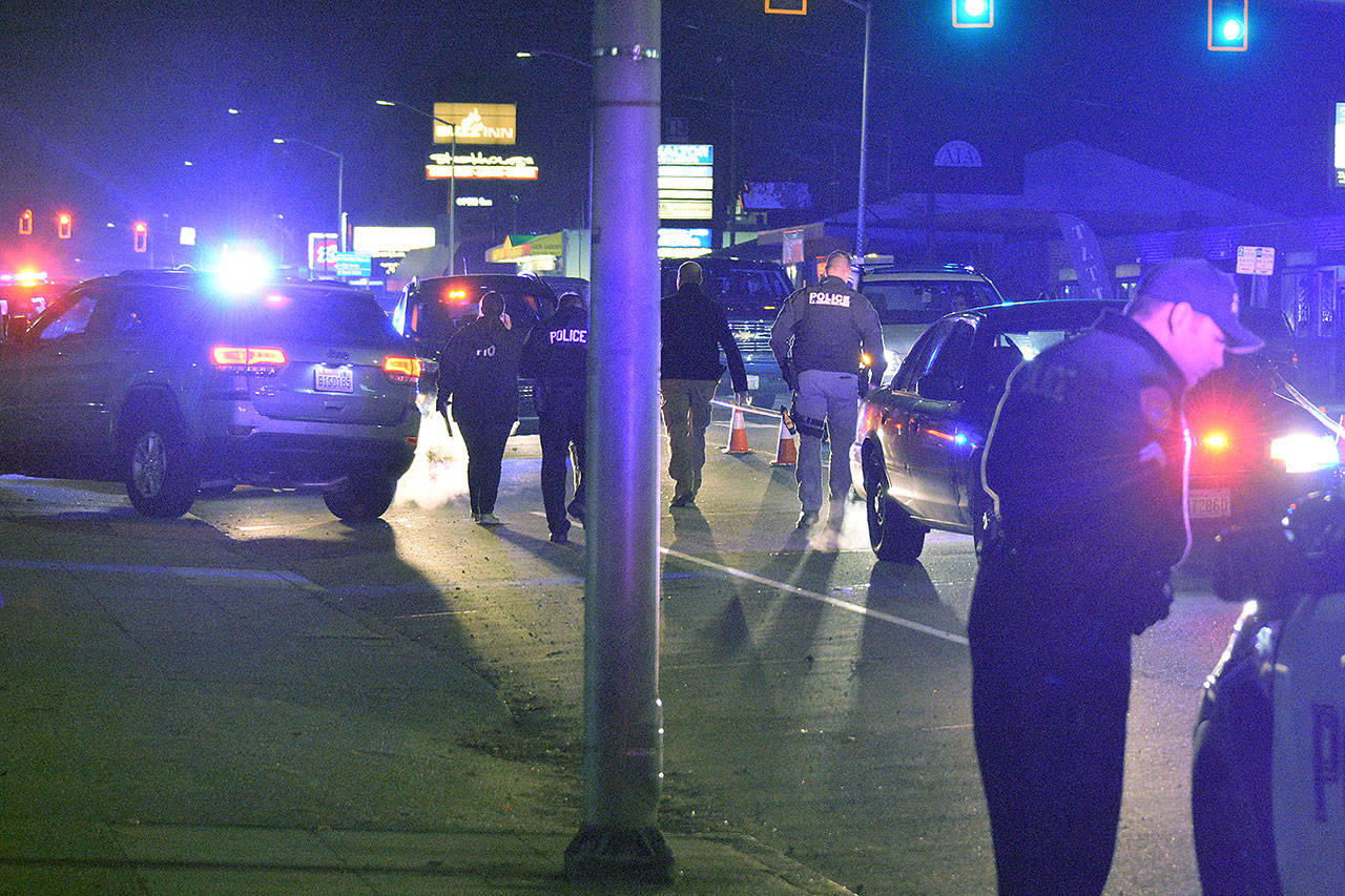 Police investigate after an officer used force while detaining a man Thursday evening at Broadway and 33rd Street in Everett. (Caleb Hutton / The Herald)