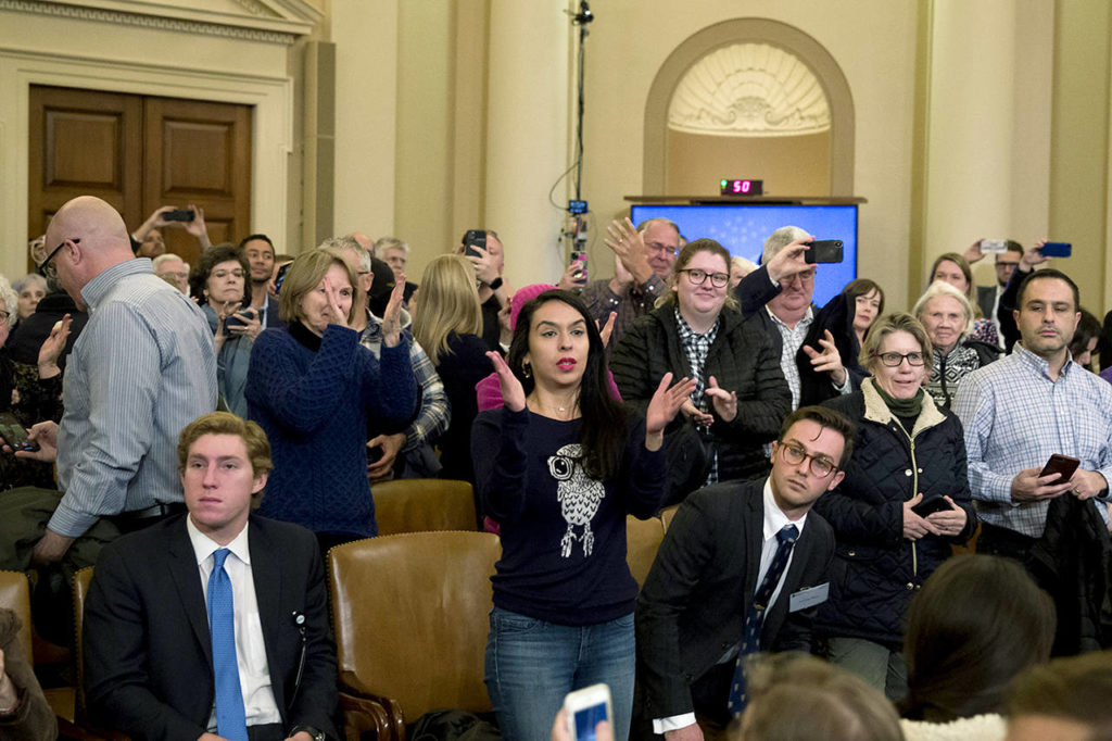 Some members of the audience stand and applaud after former U.S. Ambassador to Ukraine Marie Yovanovitch testified before the House Intelligence Committee on Capitol Hill in Washington on Friday. (AP Photo/Alex Brandon)
