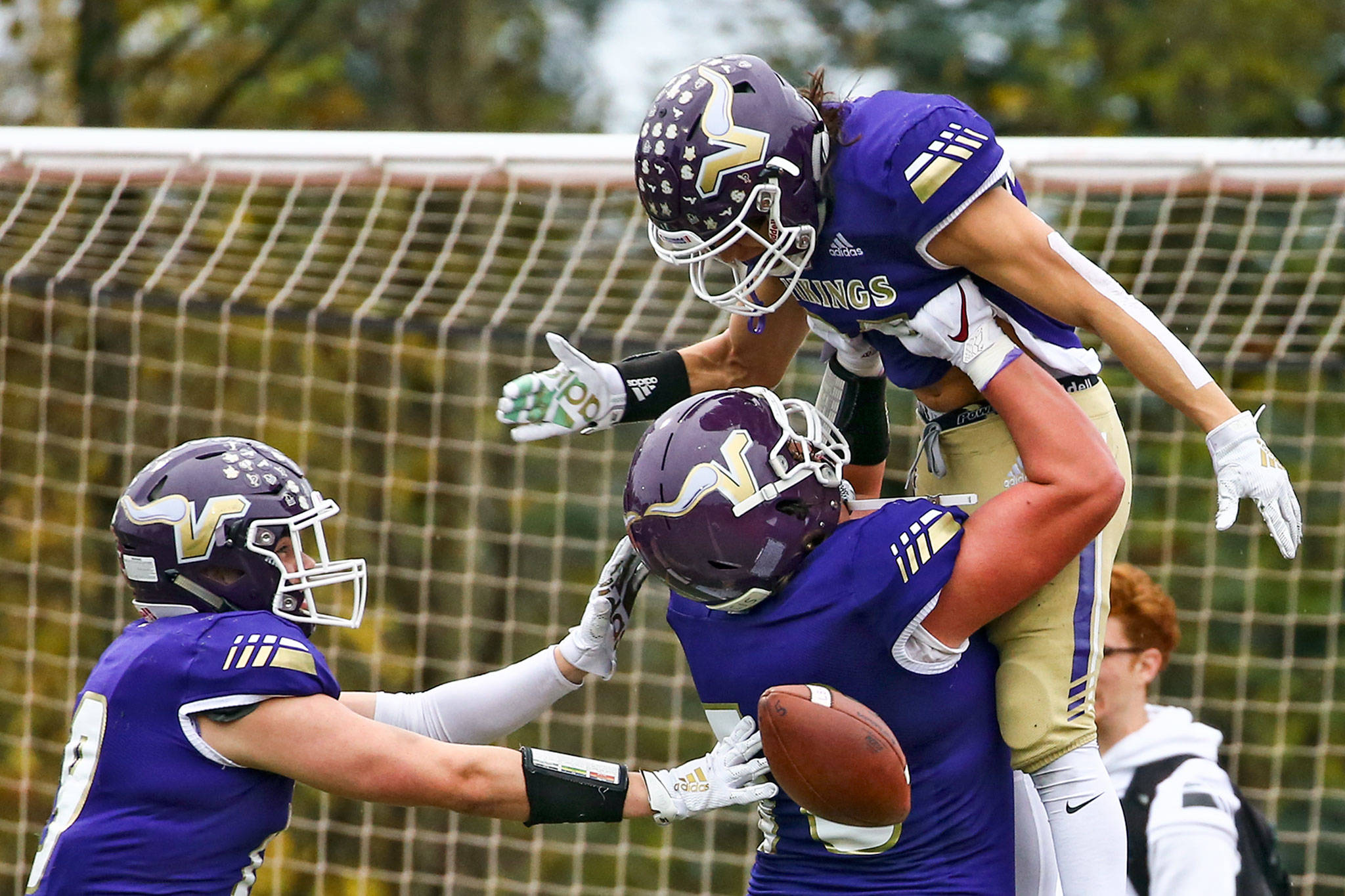 Lake Stevens’ Devin Kylany (bottom right) lifts Sergio Pelayo after Pelayo scored a touchdown during a 4A state playoff game against Union Saturday afternoon at Lake Stevens High School. Lake Stevens won 28-21. (Kevin Clark / The Herald)