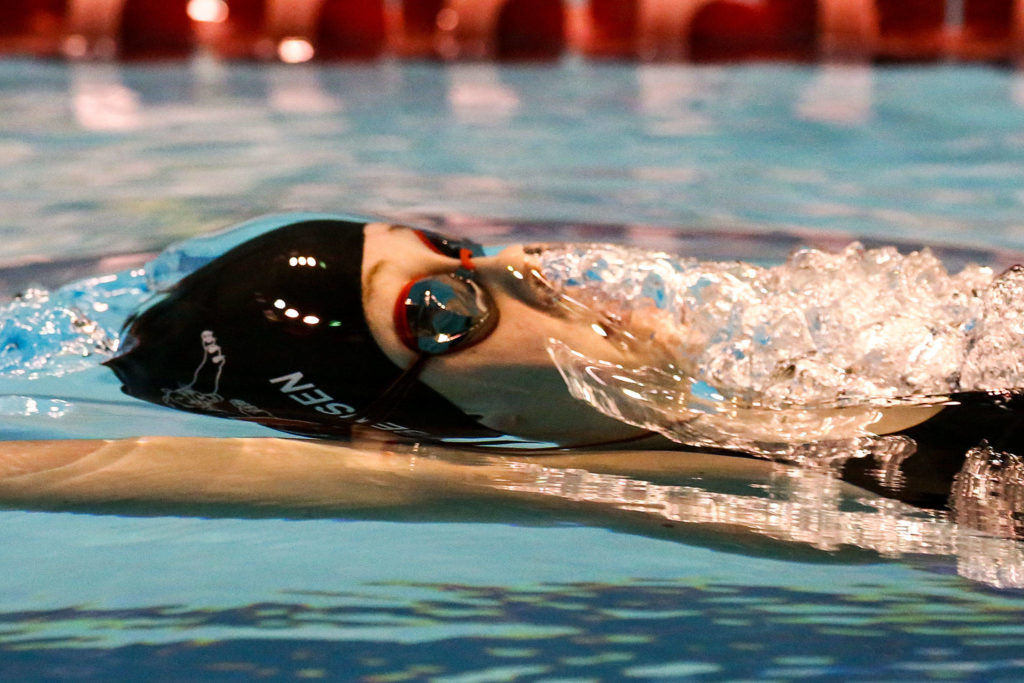 Snohomish’s Kendall Bensen competes in the 100 yard backstroke finishing sixth Saturday evening during the 3A Girls Swim & Dive Championship at King County Aquatics Center in Federal Way on November 16, 2019. (Kevin Clark / The Herald)
