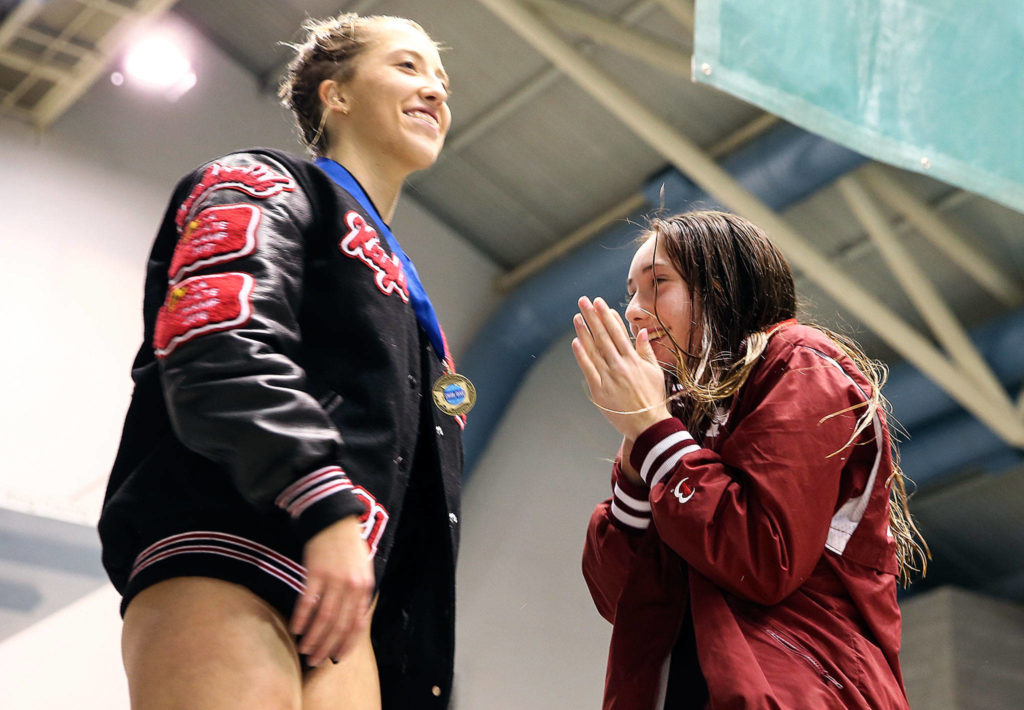 Snohomish’s Kayli Kersavage and Mercer Island’s Brooke Andrews on the champions podium Saturday evening during the 3A Girls Swim & Dive Championship at King County Aquatics Center in Federal Way on November 16, 2019. (Kevin Clark / The Herald)
