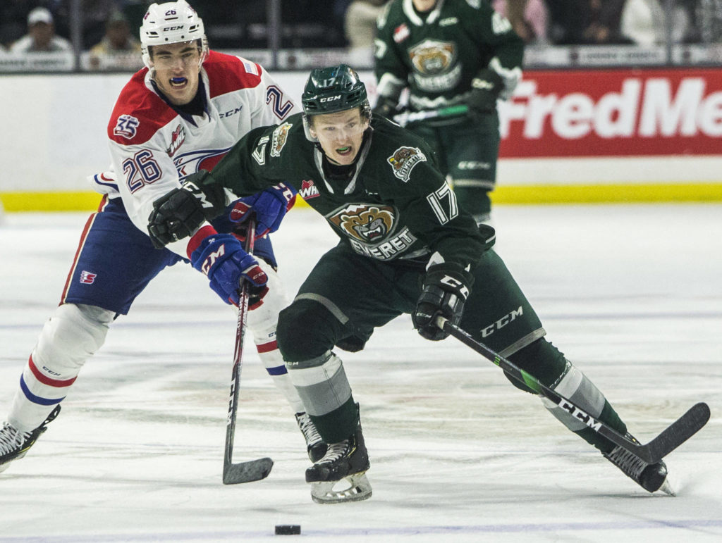 Silvertips’ Jackson Berezowski beats Spokane’s Jack Finley to the puck during the game against the Spokane Chiefs on Nov. 17, 2019 in Everett, Wash. (Olivia Vanni / The Herald)
