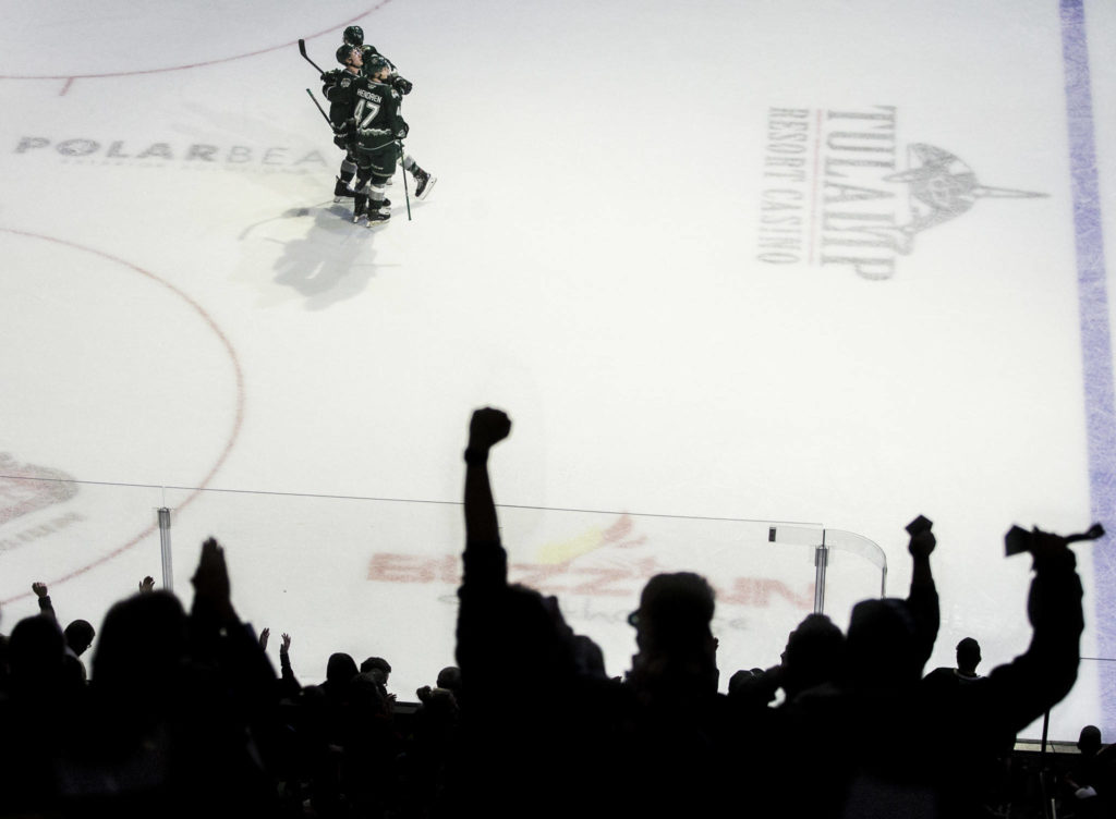 Silvertips’ Parker Hendren and Max Patterson congratulate Gianni Fairbrother on his goal as the crowd cheers during the game against the Spokane Chiefs on Nov. 17, 2019 in Everett, Wash. (Olivia Vanni / The Herald)
