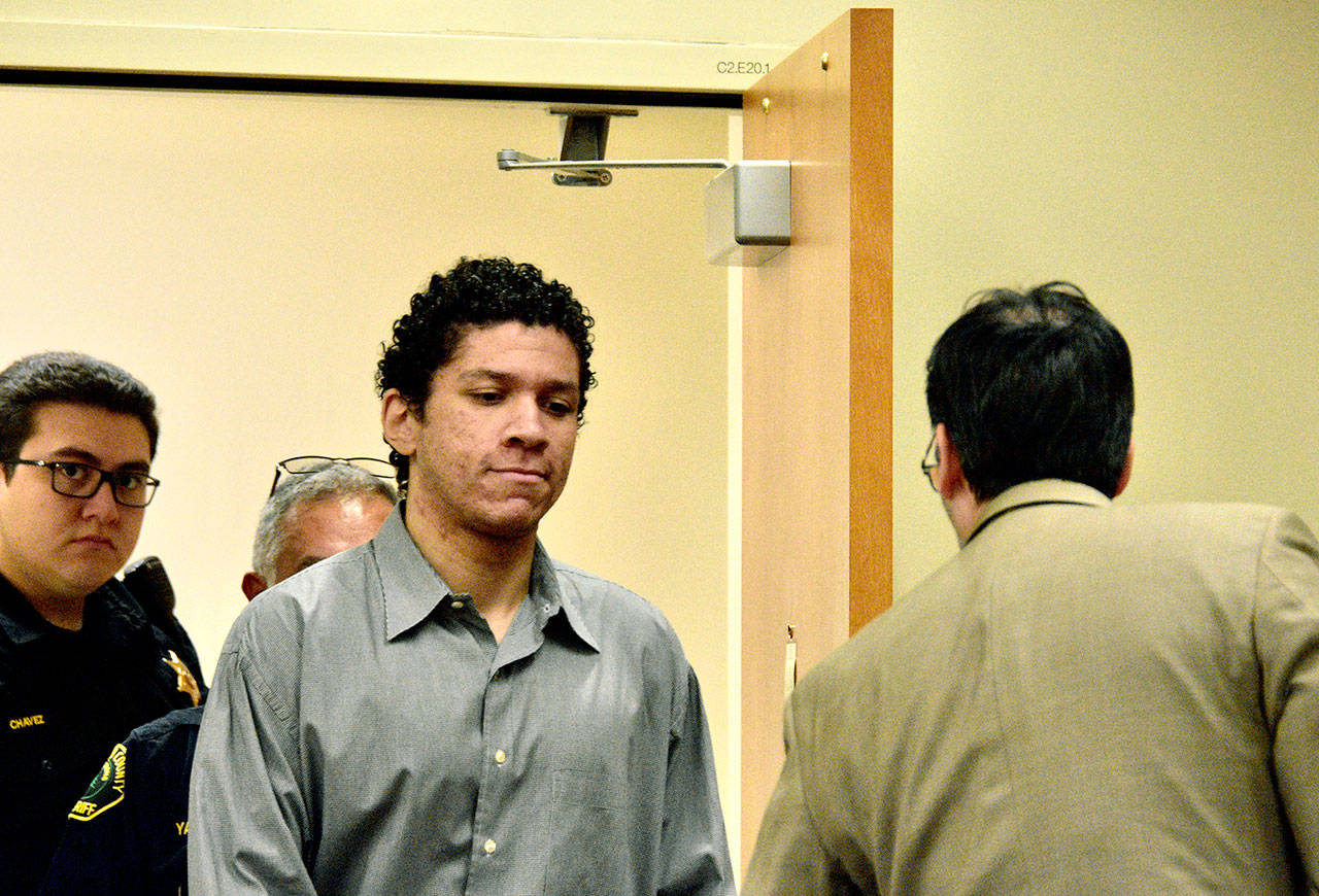 Matthew McGowan (center) enters the courtroom to hear the jury‘s verdict in his murder trial on Monday at Snohomish County Superior Court in Everett. (Caleb Hutton / The Herald)