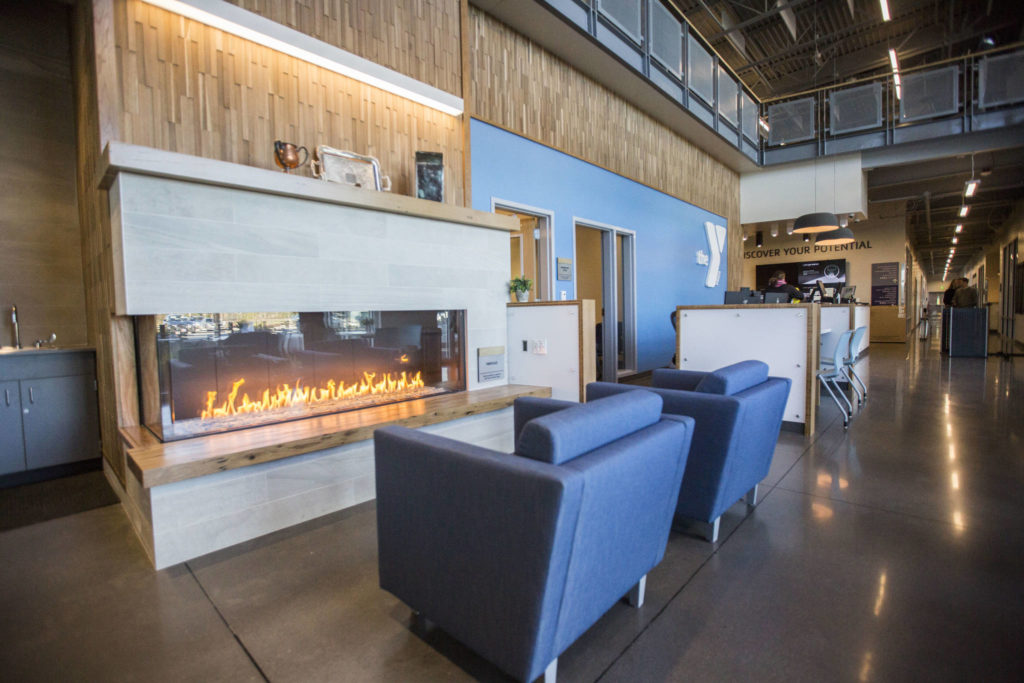 Artifacts from the former Everett YMCA are displayed on a fireplace in the new center Thursday. (Olivia Vanni / The Herald)
