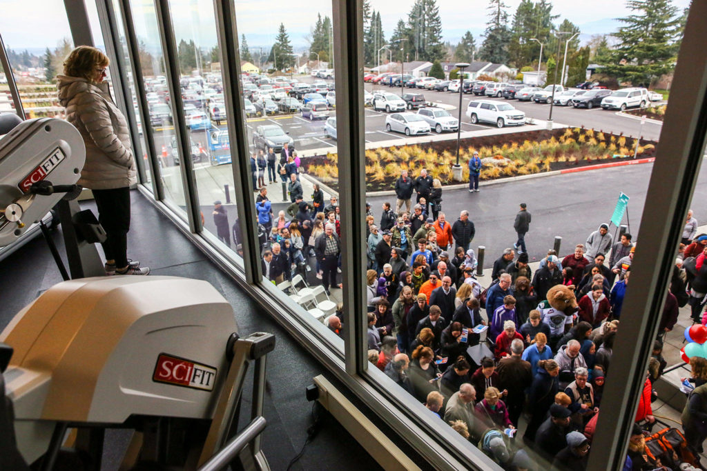 Hundreds make their inside the soon-to-be opened Everett YMCA after the ribbon-cutting ceremony Saturday morning. (Kevin Clark / The Herald)
