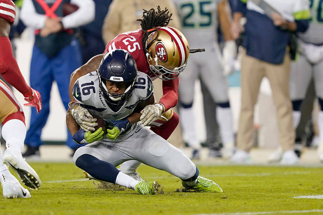 San Francisco’s Richard Sherman (25) tackles Seattle’s Tyler Lockett (16) during the Seahawks’ overtime victory over the 49ers on Nov. 11 in Santa Clara, California. (AP Photo/Tony Avelar)