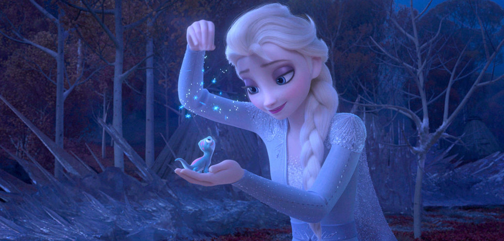 Elsa sprinkles snowflakes on Bruni the salamander in “Frozen II.” (Disney)

